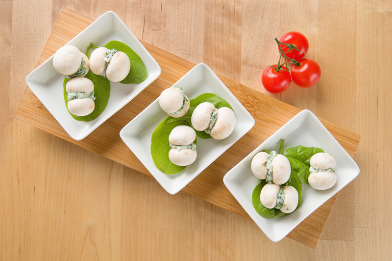 Mushrooms with feta cheese stuffing on basil leaves