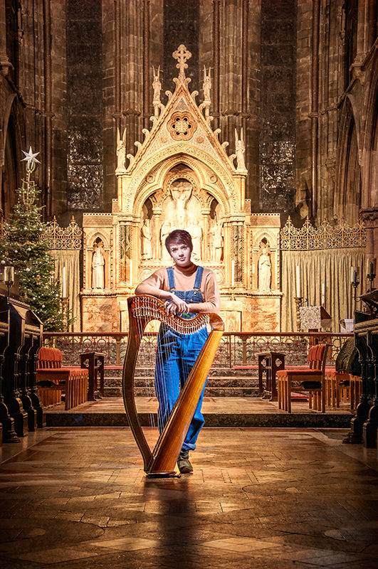 The Voice UK 2014 contestant Anna McLuckie light painting. She is standing with her harp in front of the altar at St Mary's cathedral, Edinburgh