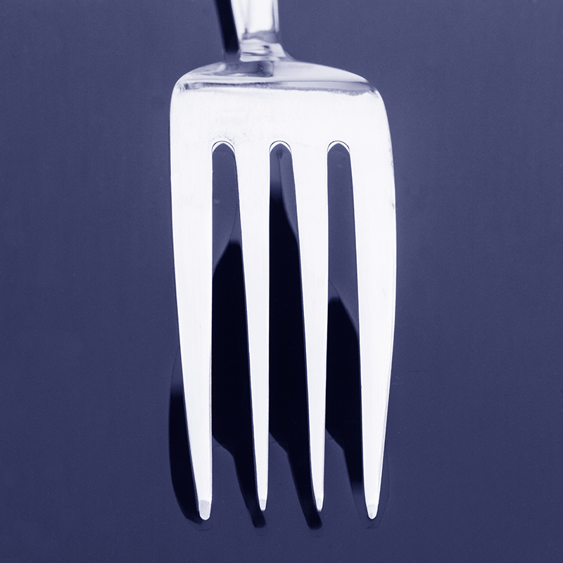 Fork on black reflective background edited with a Photoshop Duotone