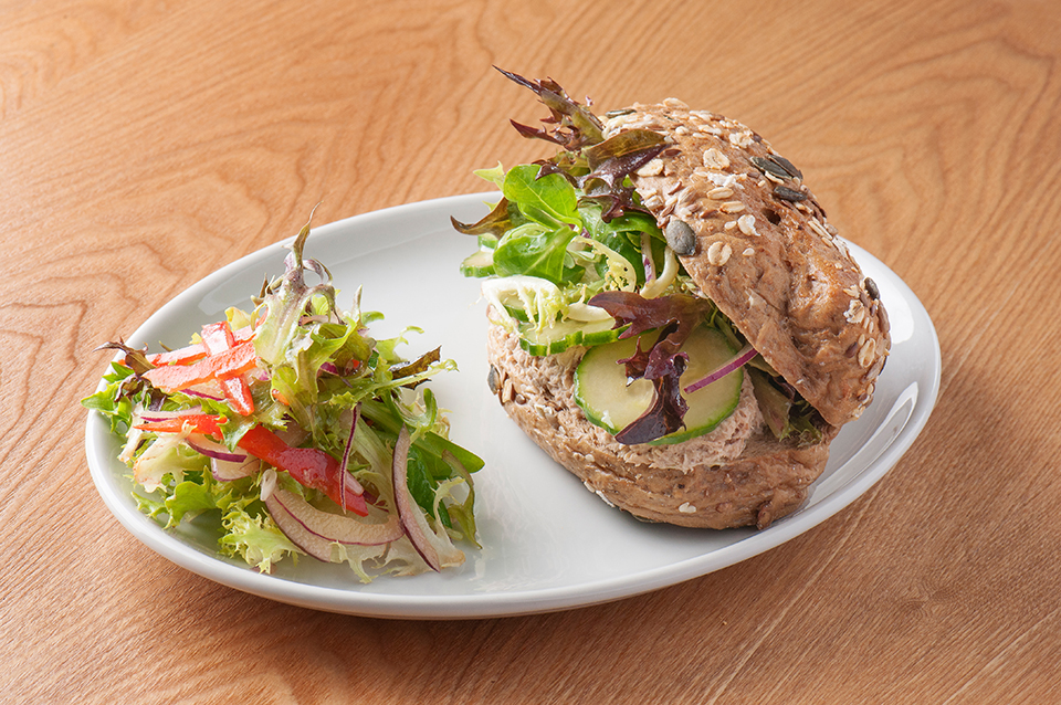 Tuna sandwich on a plate, with a side salad