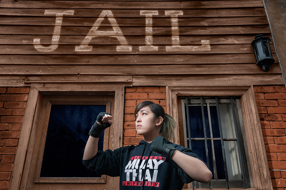 Wild West Morningside jail in Edinburgh, with model wearing a University of Edinburgh Muay Thai sweater