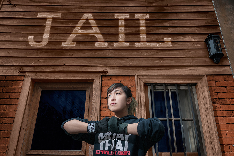 Wild West Morningside jail in Edinburgh, with model wearing a University of Edinburgh Muay Thai sweater