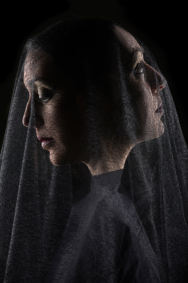 In camera double exposure portrait of Zoja Dravai with a black veil on her face