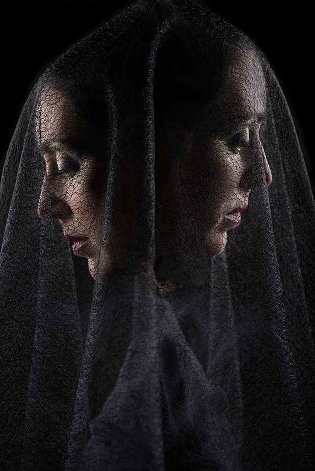 In camera double exposure  portrait of Zoja Dravai with a black veil on her face