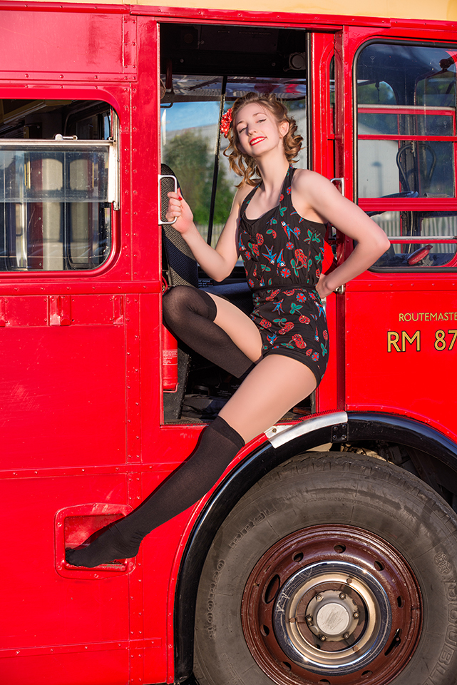 Circus artist Rosella Elphinstone on the driver side of a vintage double-decker bus