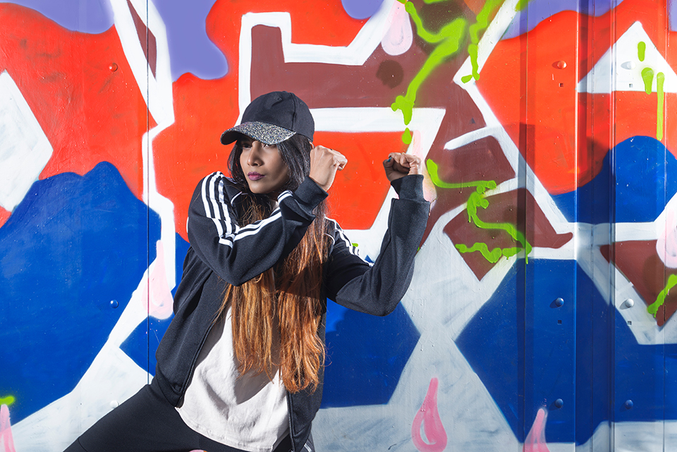 Hip Hop dancer Savitha Devi in front of graffiti mural
