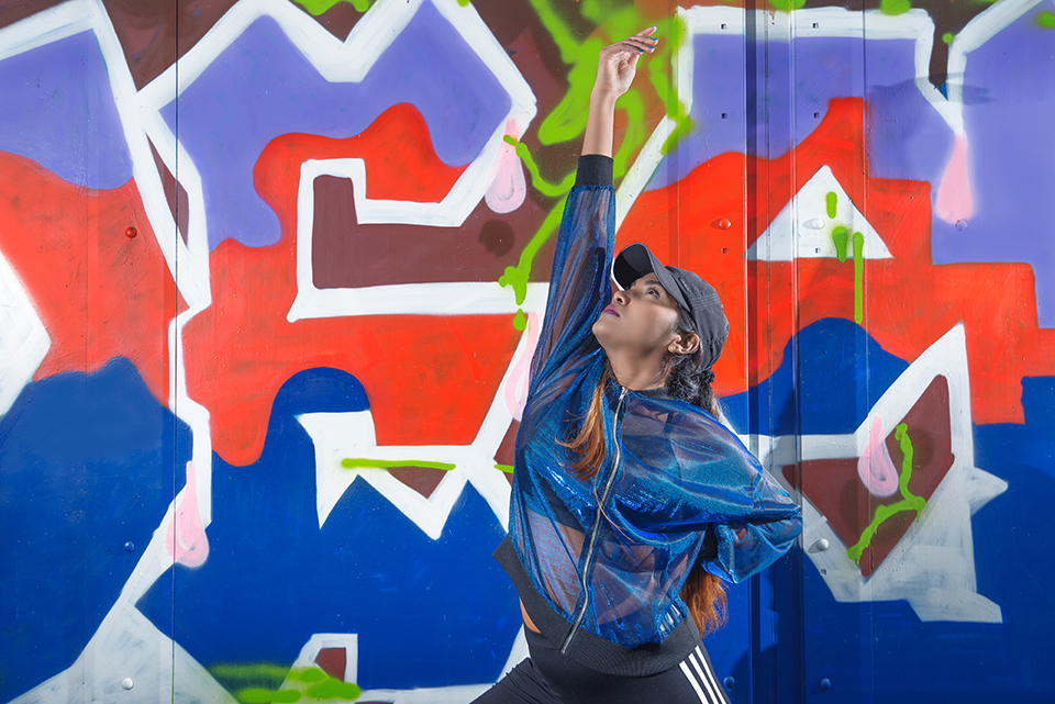 Hip Hop dancer Savitha Devi in front of graffiti wall