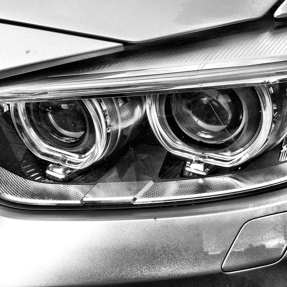 Black & white photograph of car headlight