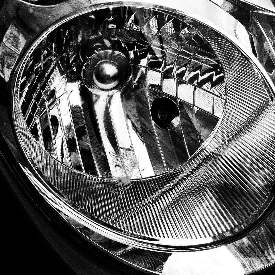 Black & white photograph of car headlight