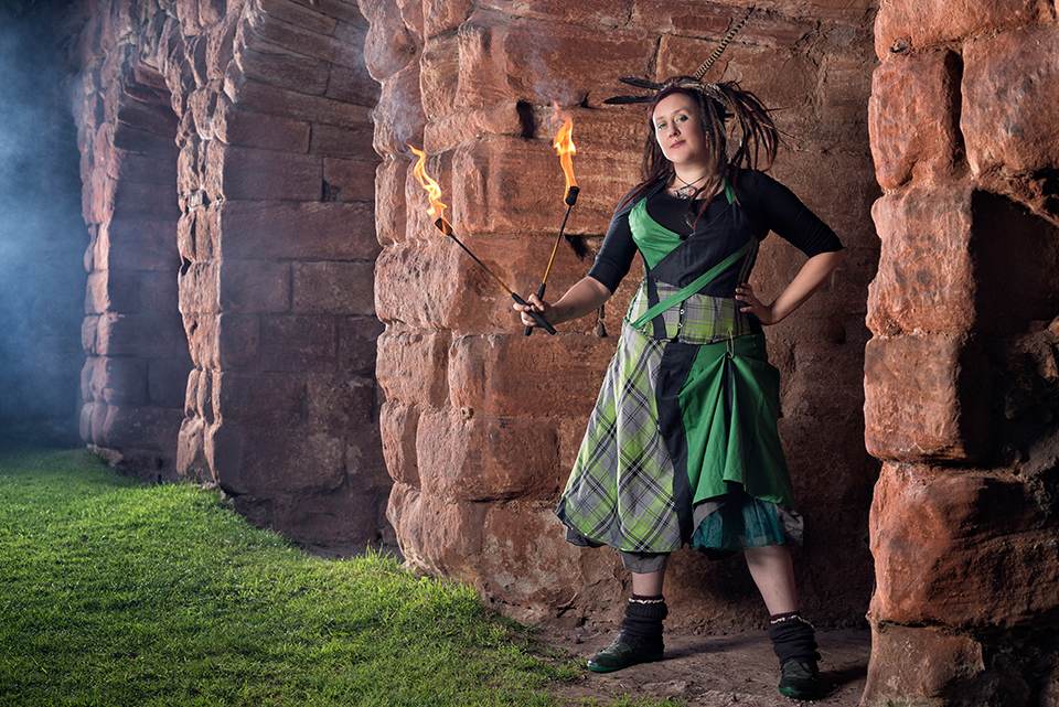 Jess in Celtic outfit handling fire at Roslin Castle