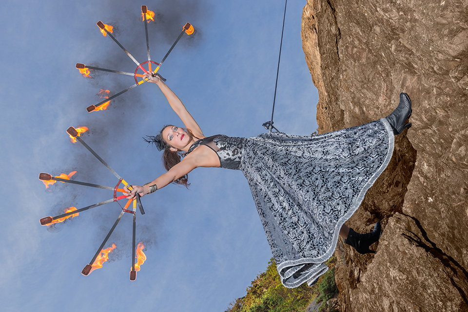 Circus artist Zoja Dravai rappelling with fire