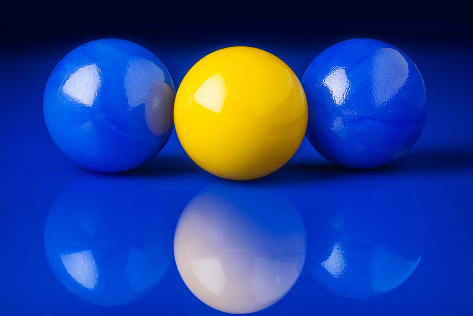 Two blue marbles and one yellow marble
