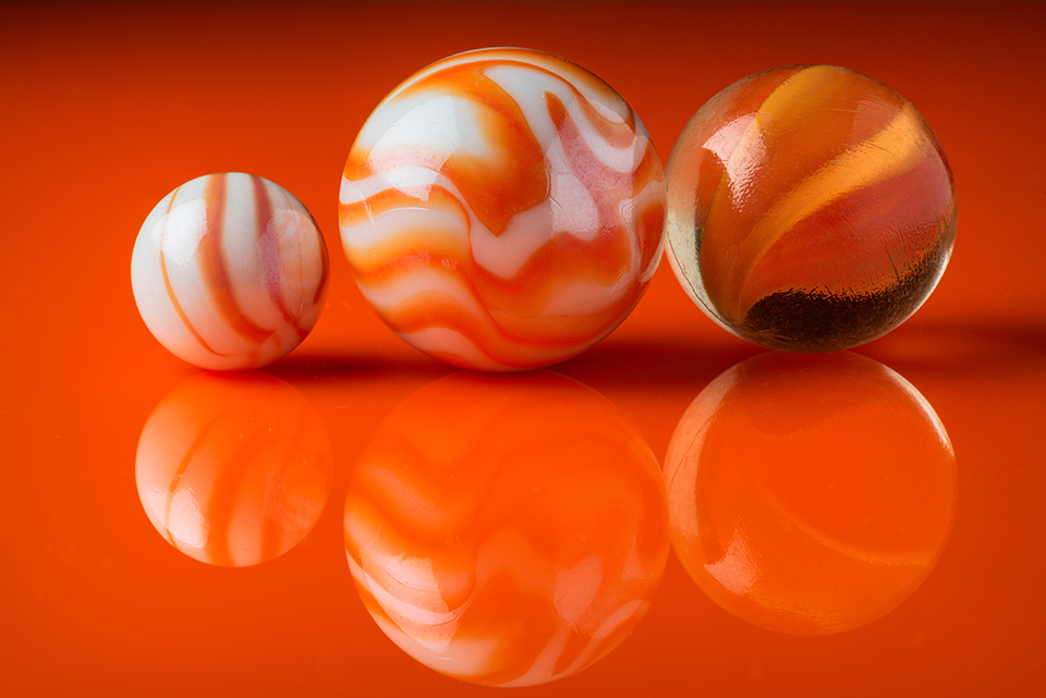 Three orange marbles