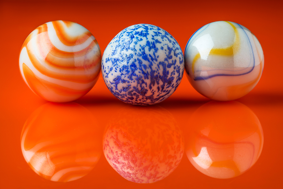 Orange, blue, white yellow and blue marbles.