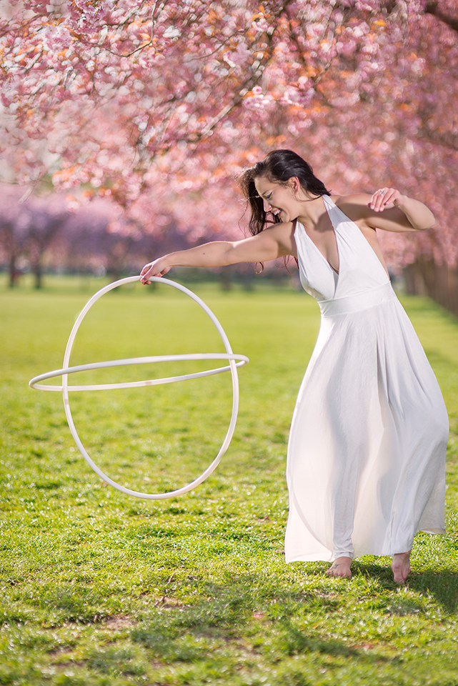Jusztina Hermann with hoops under cherry blossoms