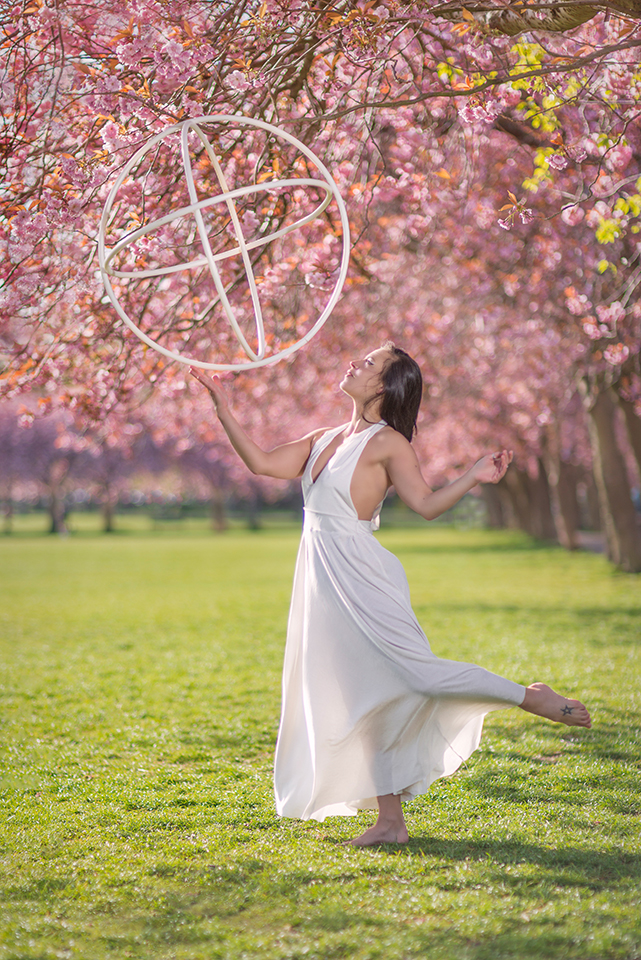 Jusztina Hermann with hoops under cherry blossoms