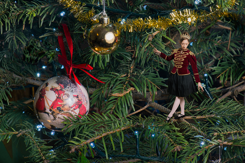 Photomontage of a young lady in a Nutcracker doll outfit in a Christmas tree