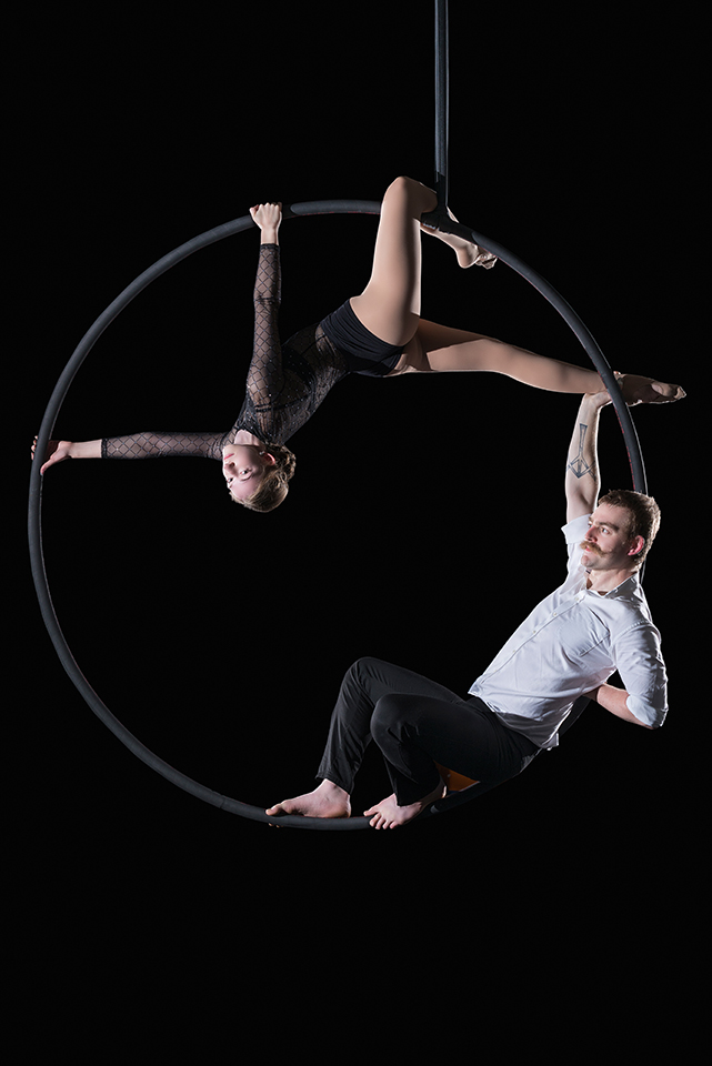 Cyr wheel duo act posing with black background