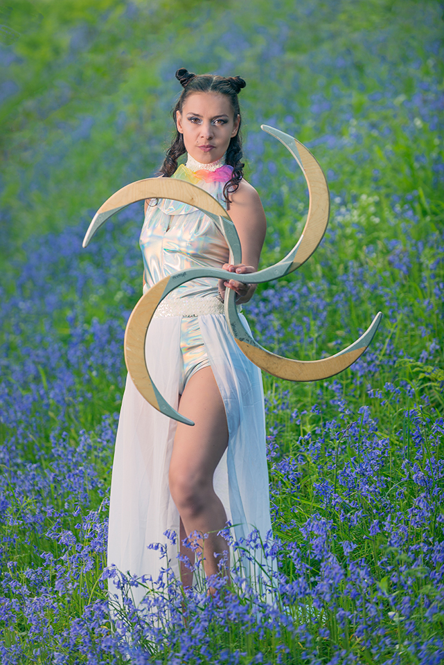 Circus artist Jusztina Hermann posing in a field of bluebells