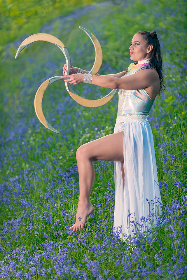 Circus artist Jusztina Hermann in a field of bluebells