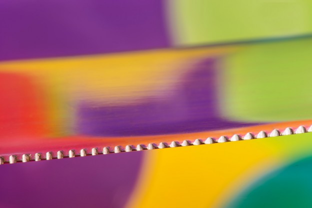 Close-up of kitchen knife on a colourful background with reflections