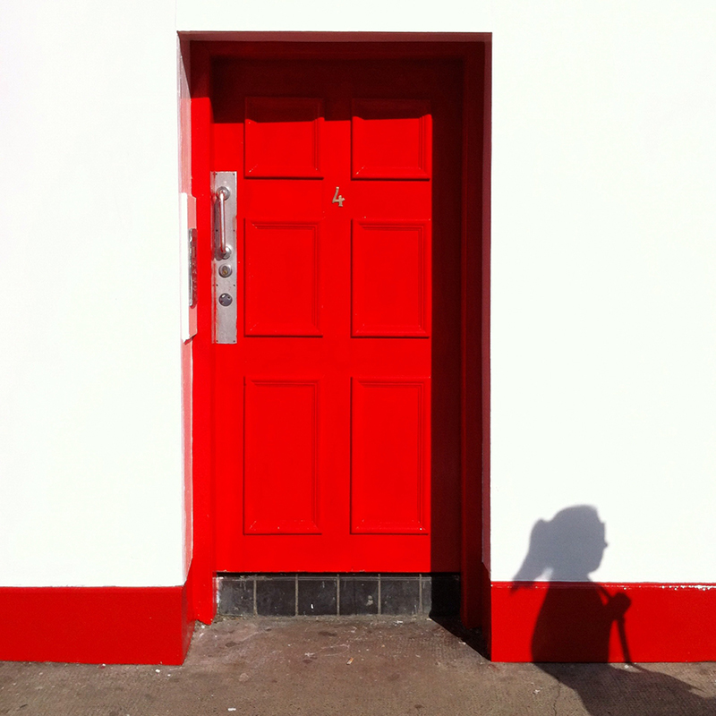 Red door with shadow of person. Taken with iPhone