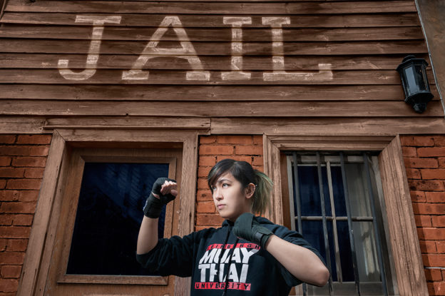 Wild West Morningside jail in Edinburgh, with model wearing a University of Edinburgh Muay Thai sweater