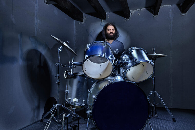 drummer matteo at drum kit in attic