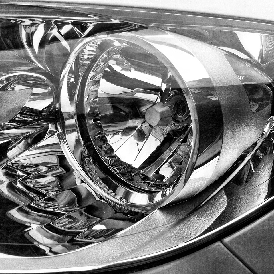 Black & white photograph of car headlight