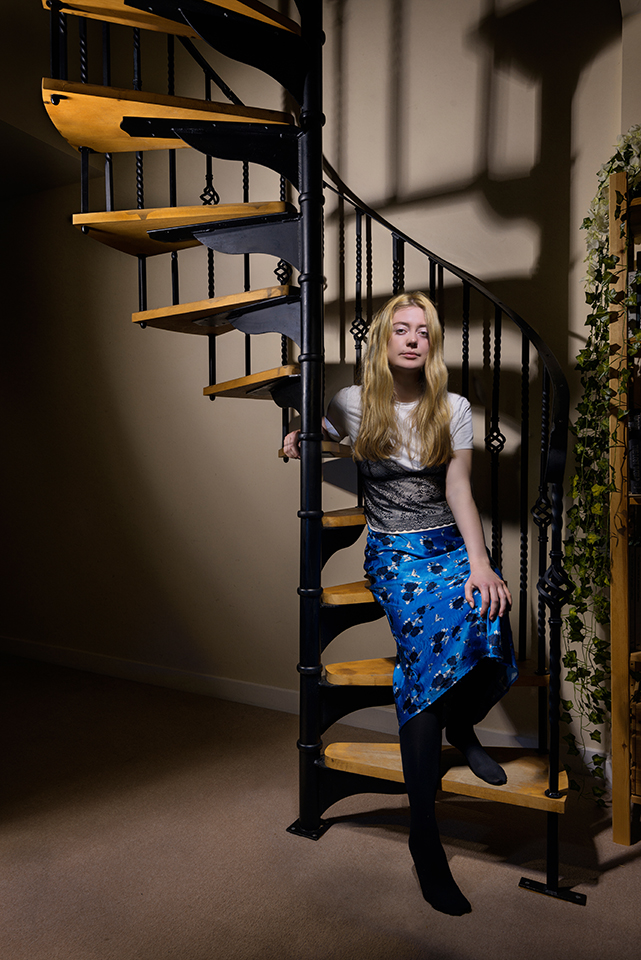 Light painting of singer Katie on a staircase looking at the camera